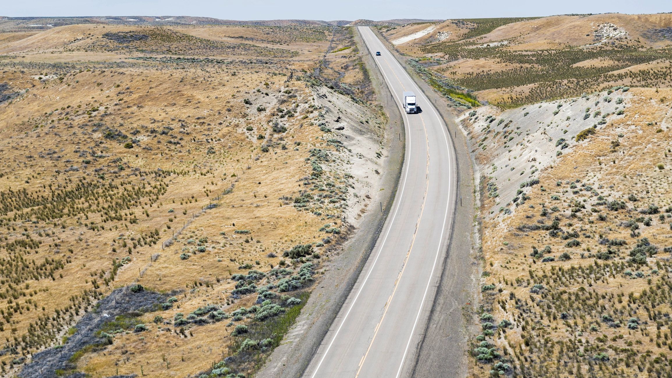 Aerial view of trucks traveling on a rural highway